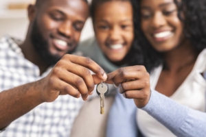 Family holding up house keys